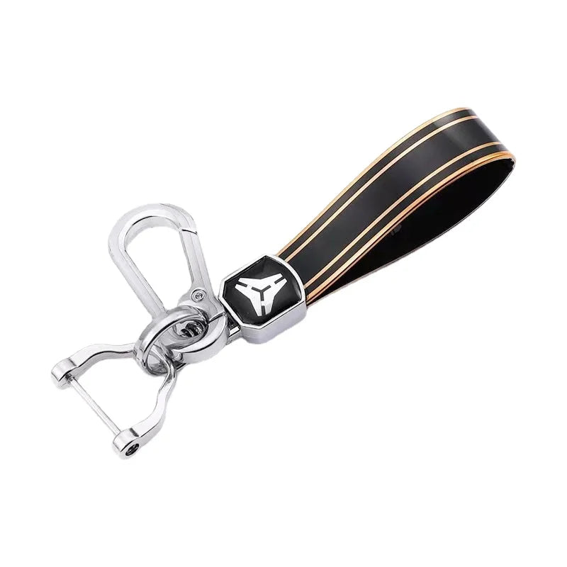 A black and gold durable TPU car key case cover with a silver clasp.