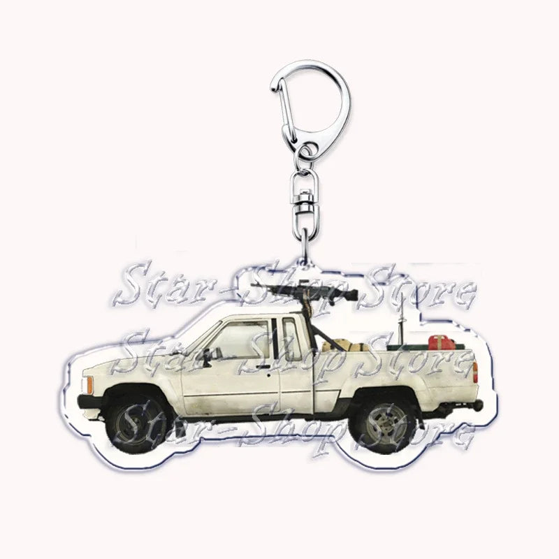 A silver metal key ring attached to a miniature off-road truck model.