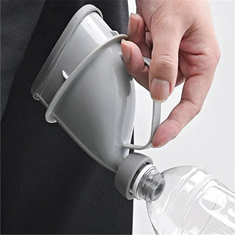 A hand is holding a portable reusable urinal funnel, which is attached to a clear bottle.