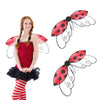 A girl wearing a red ladybug wing costume set with black and red polka dots on the wings.