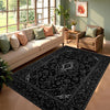 A black and white ornate area rug featuring a traditional pattern placed in a modern living room setting.