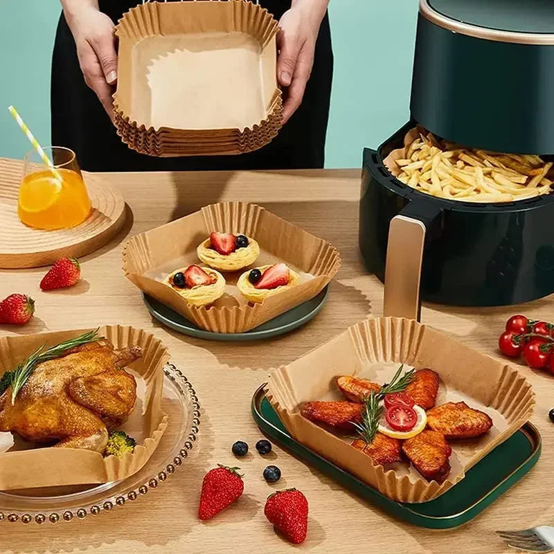 A set of disposable parchment paper liners is shown with food items and a cooking pot.
