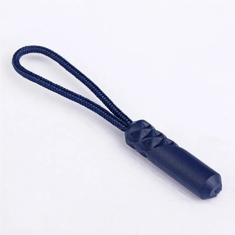 A dark blue replacement zipper pull with a nylon cord attached.