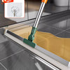 A silicone scraper broom and squeegee tool is shown cleaning a kitchen sink.