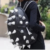 Black riveted PU leather backpack worn by a person, shown from the back.