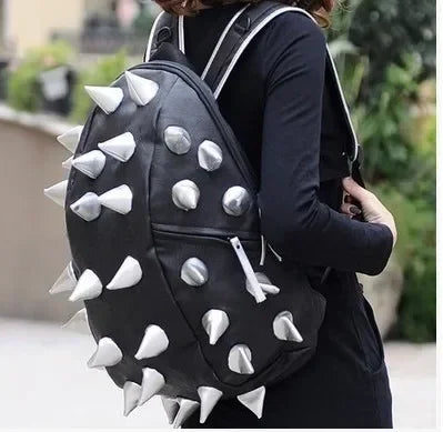 Black riveted PU leather backpack worn by a person, shown from the back.