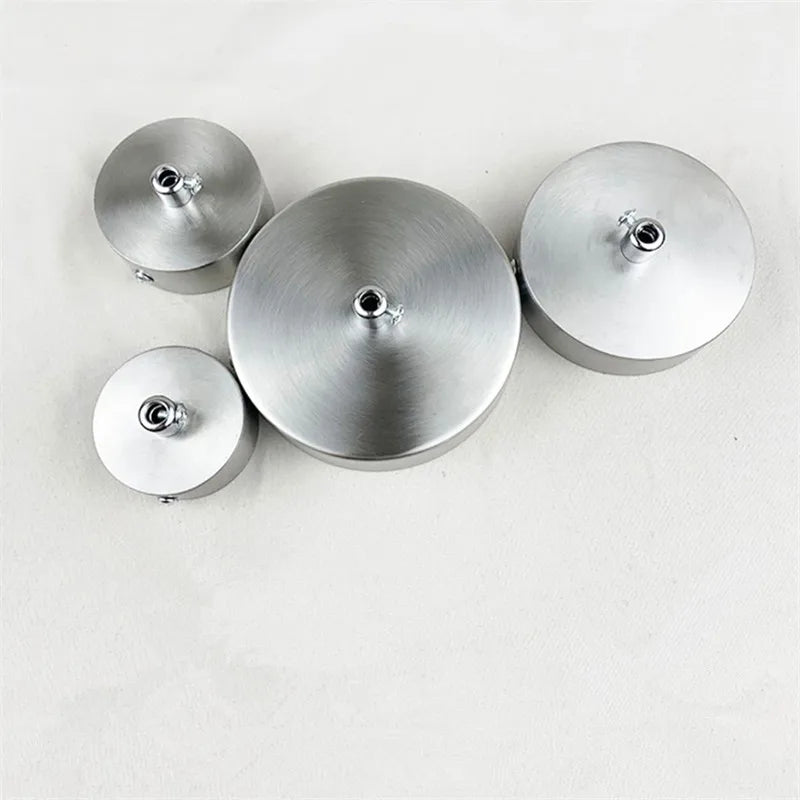 Three polished stainless steel ceiling mount canopies for pendant lights arranged horizontally.