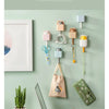 Office hanging sundries featuring adorable cat-shaped adhesive hooks on a light green wall.