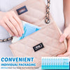 A hand is opening a beige quilted pouch containing individual disposable toilet seat covers for travel.