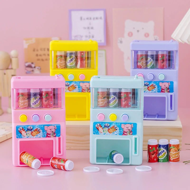 A set of colorful interactive vending machine toys featuring play coins and drinks in pink, yellow, and purple.