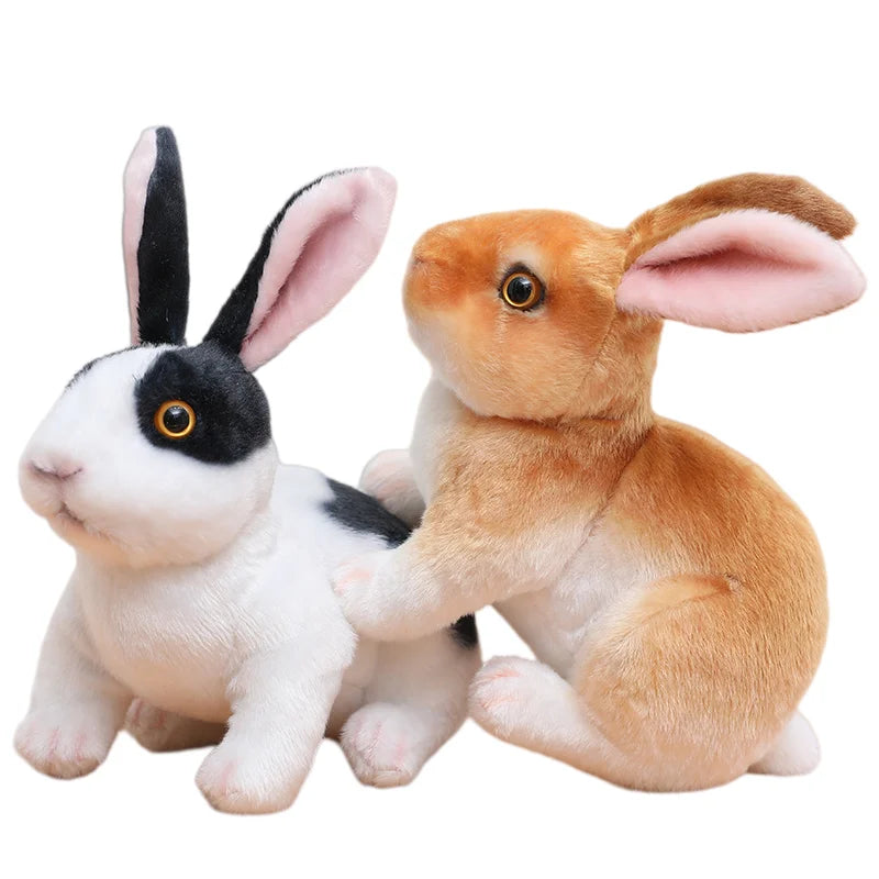 A white and black plush rabbit stuffed animal sitting on a white background.