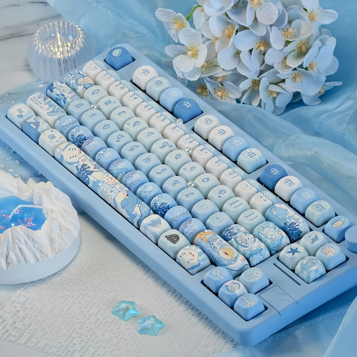 Ocean blue MOA Profile PBT keycaps for mechanical keyboards displayed on a white cloth.