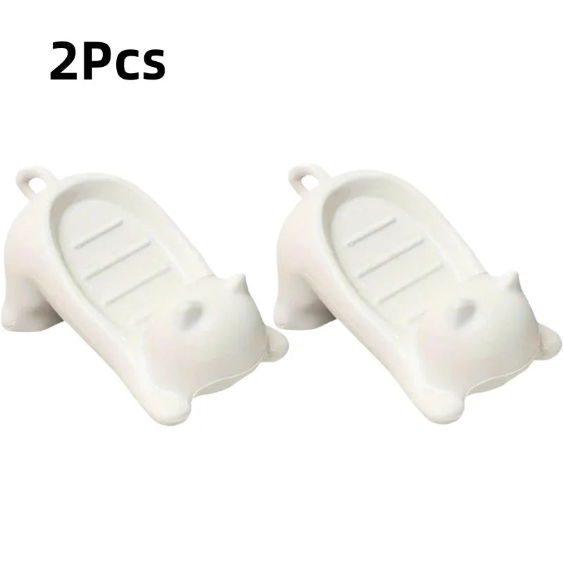 Two white cat-shaped soap dishes with drainage trays
