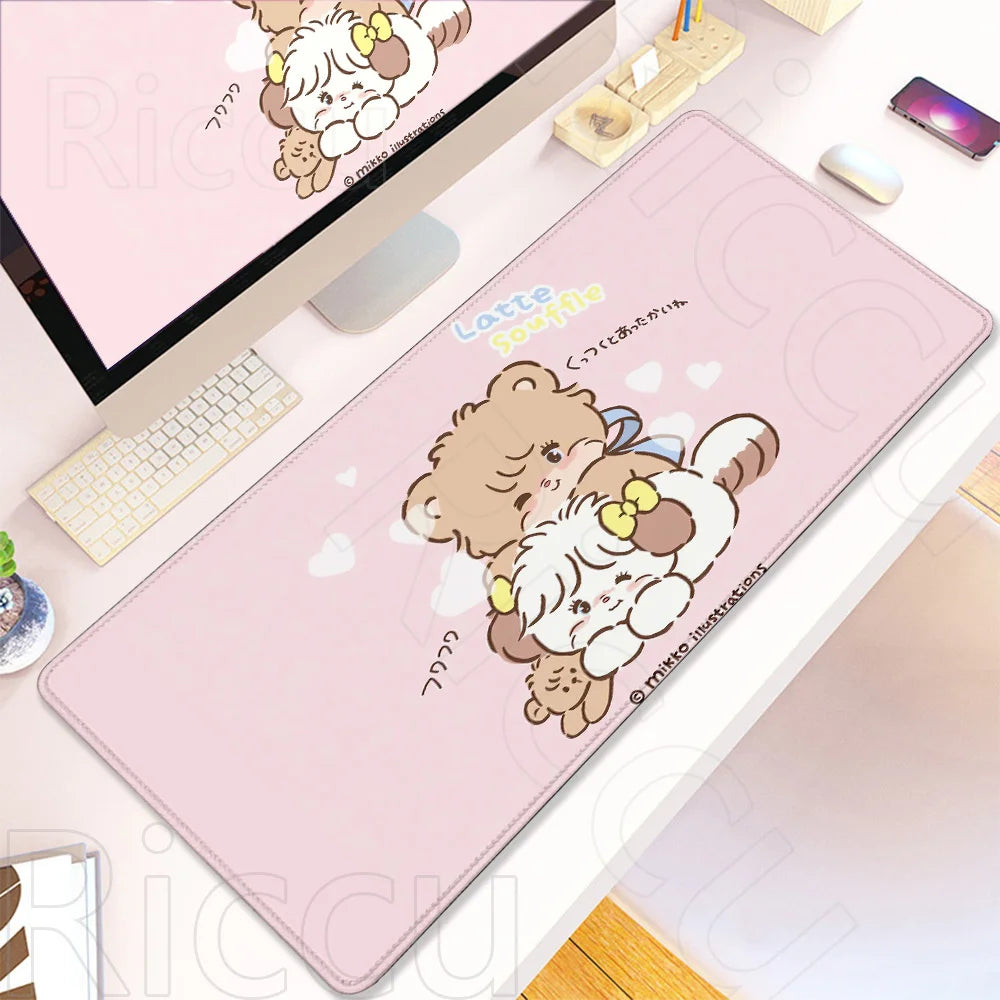 A pink kawaii cartoon desk mat featuring a teddy bear and a kitten, displayed next to a laptop.