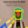 A hand is holding a blue air-powered dart gun aimed at a green duck shooting target game.