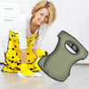 A woman wearing yellow overalls and gloves is holding a green soft foam kneepad for gardening or sports.