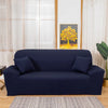 A navy blue silky soft stretchable sofa cover displayed on a couch in a bright room.