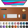 A desk pad featuring a laptop, keyboard, mouse, and a coffee cup on a brown leather surface with various color swatches below