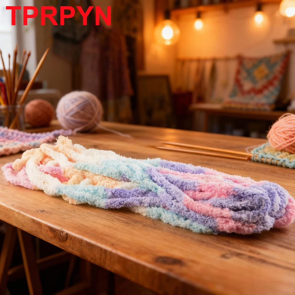 A long piece of multicolored chunky acrylic yarn is displayed on a wooden table.