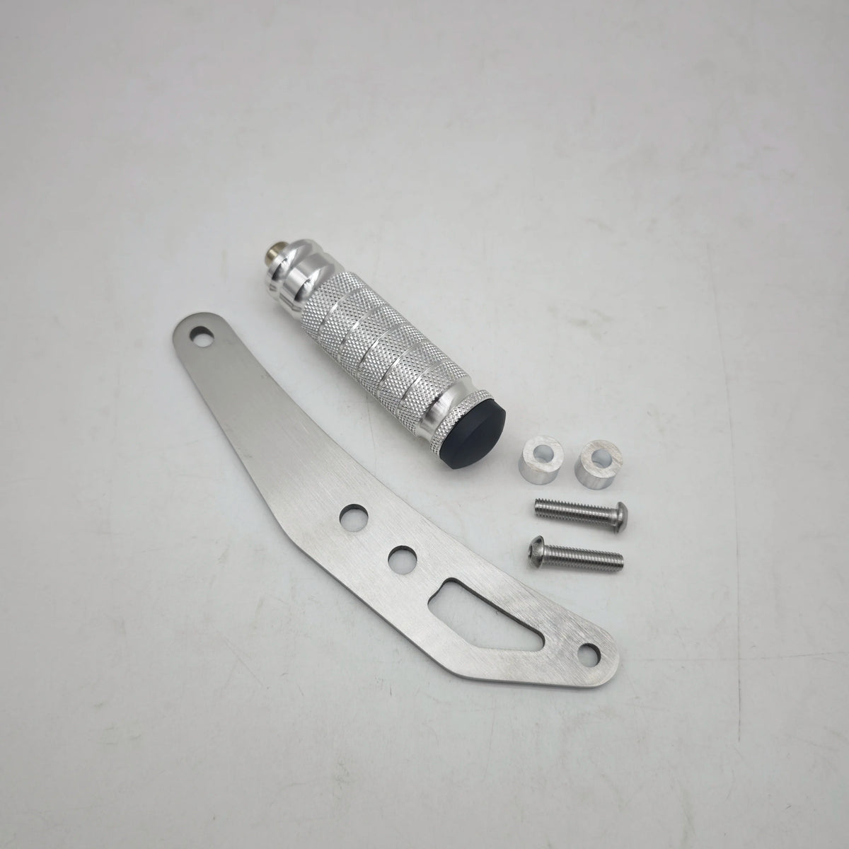 A set of CNC aluminum foot pegs and mounting hardware for electric dirt bikes.