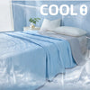 Light blue cooling quilt draped over a bed, with ice or mist effects in the background.