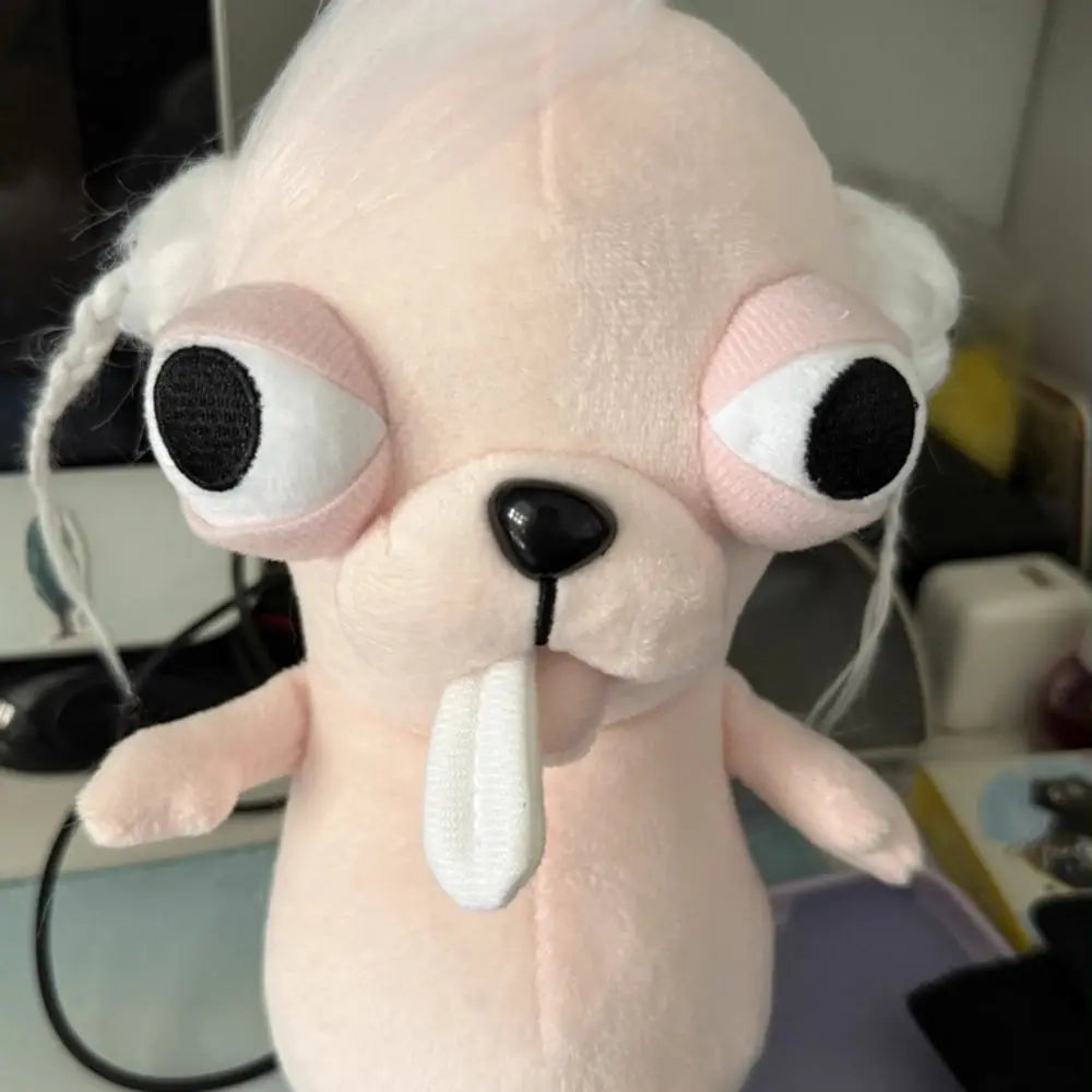 A light pink plush chihuahua dog keychain pendant with large eyes and a tongue sticking out.