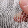 A close-up view of a 304 stainless steel mesh screen being held by a finger, showing the fine grid pattern.