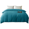 A teal washed cotton brushed duvet cover with white pillows on a bed.