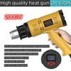 A yellow heat gun with a black handle and a digital temperature display is shown being held by a hand.