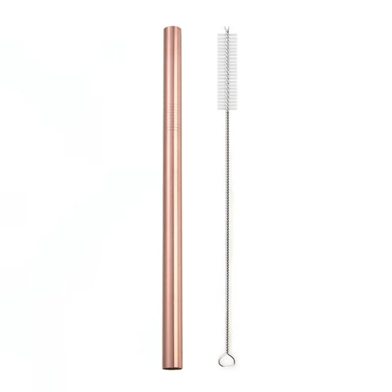 A tall, rose gold reusable stainless steel drinking straw with an attached cleaning brush.