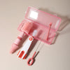 A pink silicone baby bottle cleaning set with a brush and a cleaning tool displayed in an open plastic case.