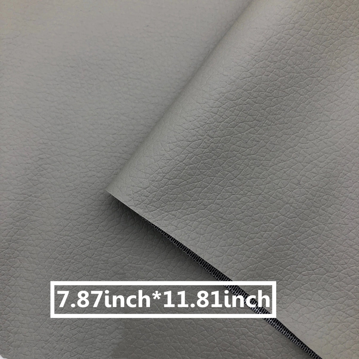 A close-up of a gray leather repair patch showing the stitching and dimensions 7.87 inch by 11.81 inch.