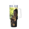 A clear tumbler filled with green liquid and a man holding a teddy bear is visible.