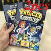 A hand holds two comic books titled Physics & Chemistry, featuring characters in lab coats and space gear.