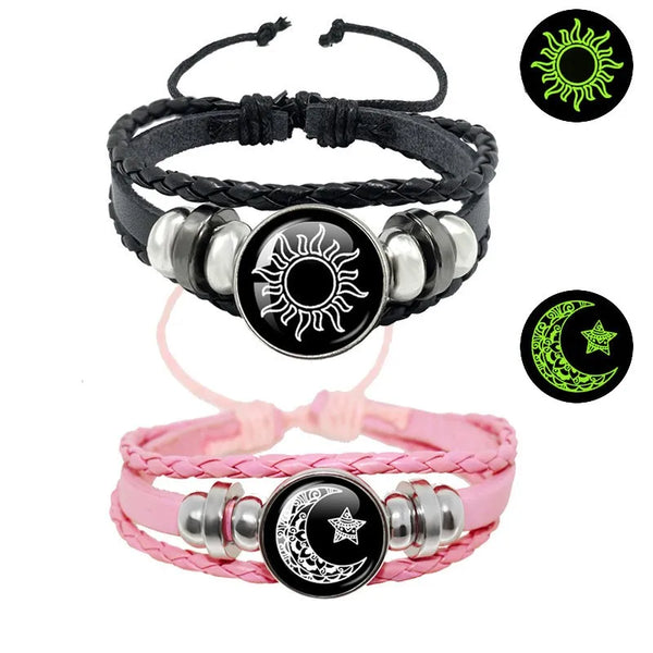 A set of black and pink leather bracelets featuring sun and moon designs.