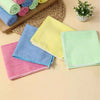 A collection of colorful microfiber cleaning cloths in various shades including pink, blue, yellow, and green, arranged on a 