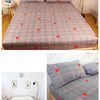 A fitted bed sheet featuring a marbled print with red hearts on a gray and pink background.