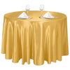 Elegant gold satin round tablecloth set for events featuring glassware and silverware.