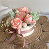 A floral silicone mold set featuring pink and green roses and filler flowers displayed on a white surface surrounded by natur