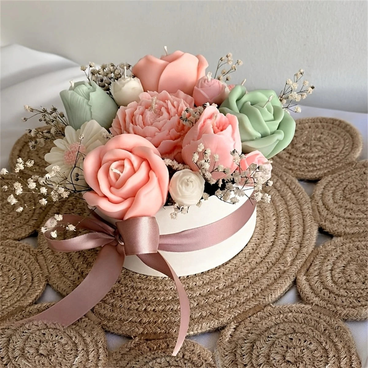A floral silicone mold set featuring pink and green roses and filler flowers displayed on a white surface surrounded by natur
