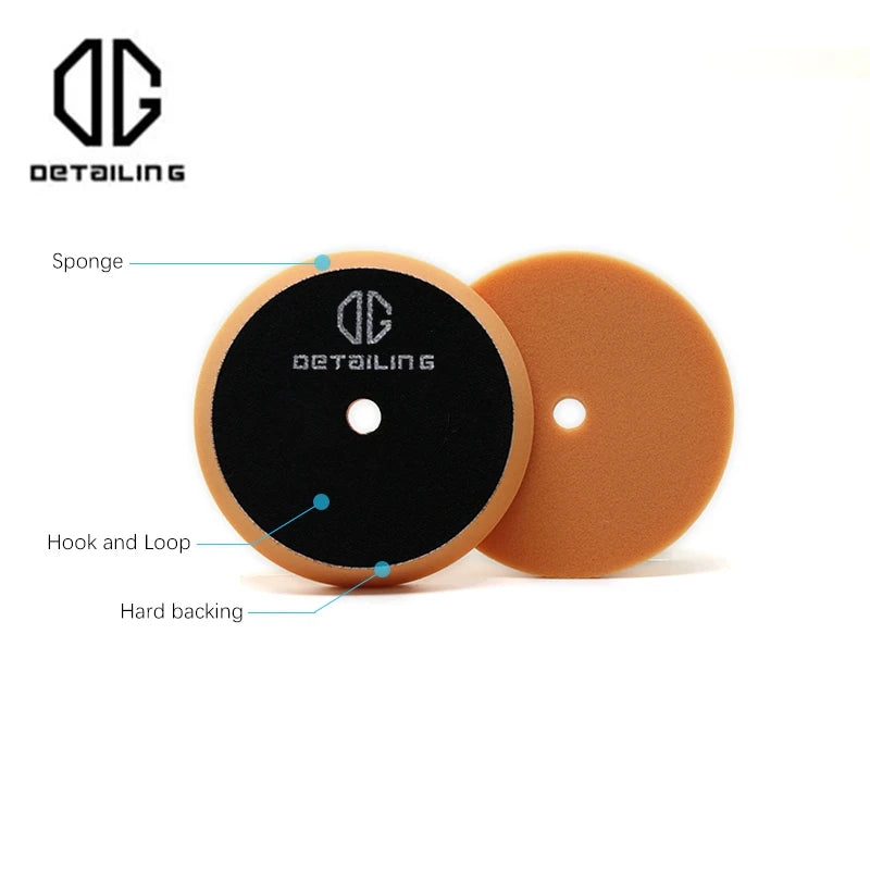 A circular black foam polishing pad with a central hole and an orange backing, used for car detailing.