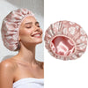 A pink satin lined waterproof shower cap for hair protection shown on a model and as a separate product view.