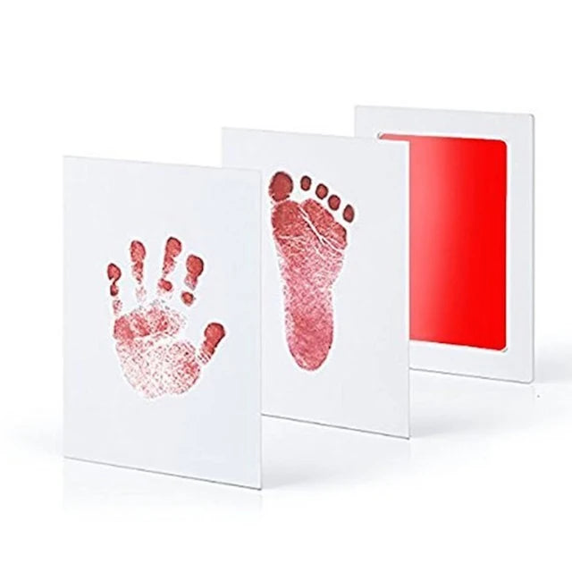 A set of white cards featuring reddish-pink hand and foot imprints on the front and a red background on the back.