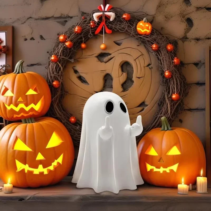 A white ghost resin statue stands in front of carved pumpkins and a wreath for Halloween decor.