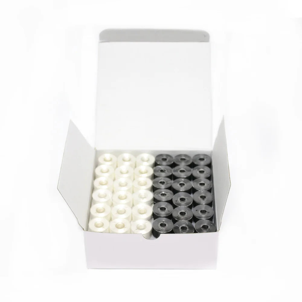 A white box containing two rows of prewound bobbins, one white and one black, for home embroidery machines.