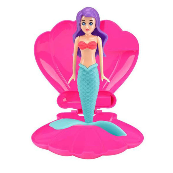 A purple mermaid doll wearing a teal scale dress is displayed in a pink dive toy container.