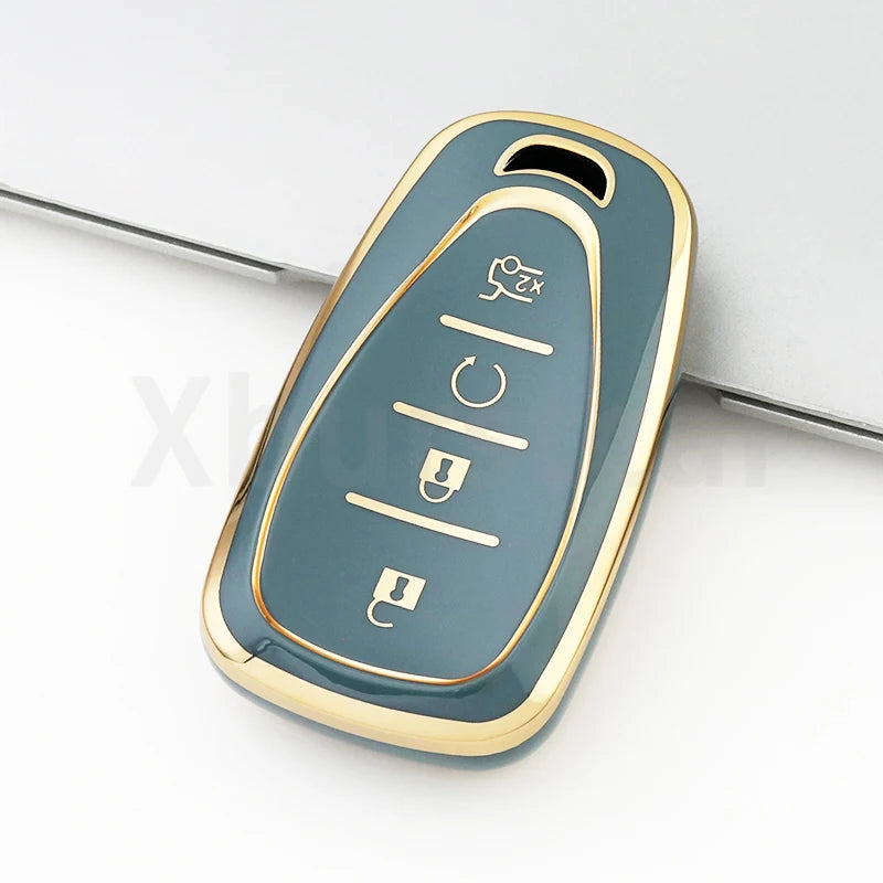 A close-up view of a light blue TPU key fob cover with gold accents, showing various buttons.