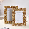 An elegant golden ginkgo leaf resin photo frame with a white background and a framed message.