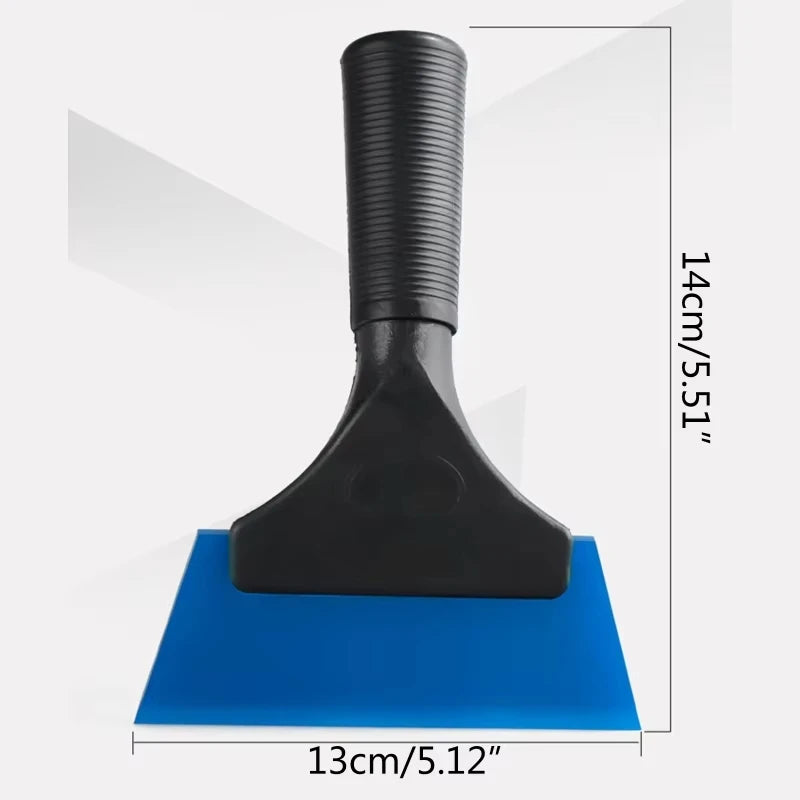 Black car window squeegee with a soft rubber blade resting on a blue surface.