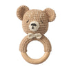 A handmade crochet bunny rattle featuring a natural wood teether ring.